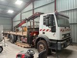 a truck with a crane on the back of it in a building