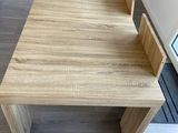 a wooden table with a bench in the middle of it
