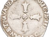a close up of a coin with a cross on it