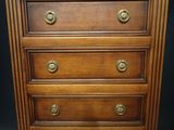 a wooden chest of drawers with brass knobs on it