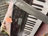 a keyboard that is wrapped in plastic and sitting on top of a box