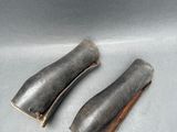 these are two pieces of metal that are sitting on a table
