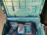 a green box with tools in it on a pallet