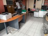 a man that is standing in front of a desk with a printer