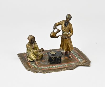 bronze figurine of a man and a woman on a rug