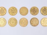 six different types of gold coins on a white surface
