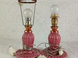 pair of pink glass table lamps with brass bases and a glass shade