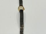 an image of a watch that is laying on a white surface