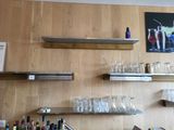 a bar with a lot of bottles and glasses on the shelves