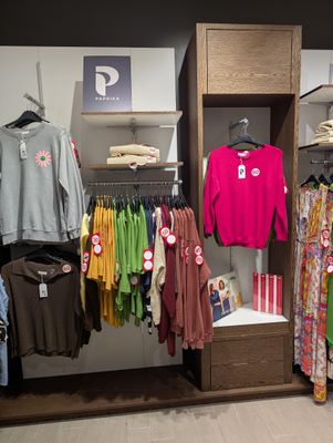 a lot of clothes that are on display in a store