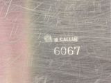 a close up of a metal plate with a number on it