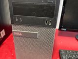 a desktop computer sitting on a red desk next to a keyboard and mouse