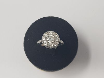une photo d'une bague en diamant posée sur un présentoir noir