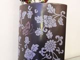 a vase with flowers in it sitting on a glass table