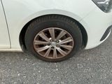 a close up of a car ' s tire on the road