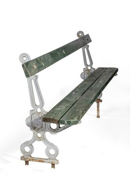 a green park bench sitting on top of a white floor