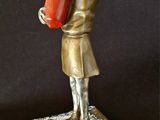 bronze statue of a woman holding a fire extinguisor on a marble base