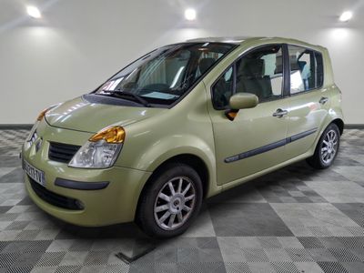 a picture of a small green car parked in a garage