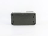 a close up of a small black box on a white surface