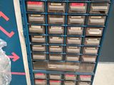 a machine that has a bunch of plastic containers on it