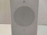 a close up of a white speaker on a white surface