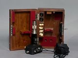 a small wooden box that has a microscope in it