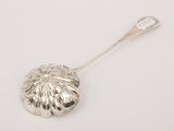 silver plated spoon with a flower design on it and a spoon in the shape of a flower