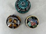 three different types of buttons on a table with a white background