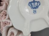 a small white plate with a blue design on it