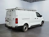 the back of a white van is parked in a large room