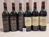 several bottles of wine are lined up on a table