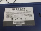 the back of a blue nintendo wii game console sitting on top of a table