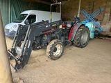 a tractor and a van in a barn with a ladder