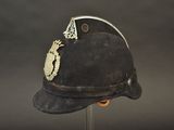 a helmet with a crown on it sitting on a stand