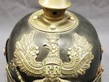 a black and gold helmet with gold decorations on it