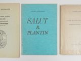 three books sitting on top of a white table next to each other