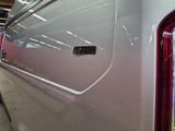 a close up of a white car with a red tail light