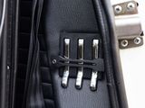 a close up of a guitar case with four keys in it