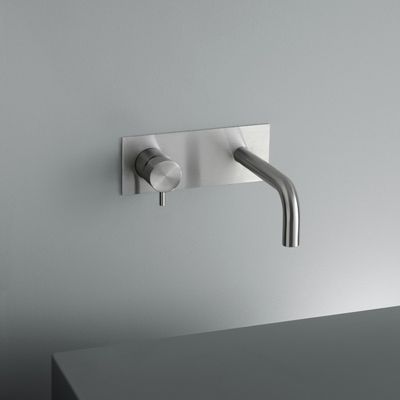 a faucet that is attached to a wall mounted faucet