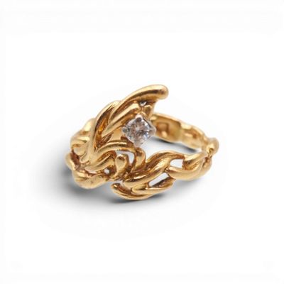 a close up of a gold ring with a diamond in the middle