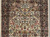 an antique persian rug with a floral design and fringes
