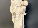 white statue of a woman holding a baby in her arms