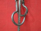 a metal hook that is attached to a red wall