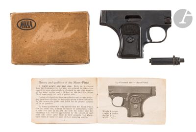 a gun and a book on a white surface
