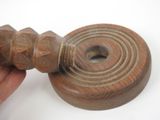 a hand holding a piece of wood that has been turned to look like a ring