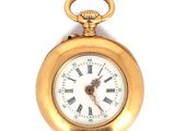 une montre de poche en or avec des chiffres romains