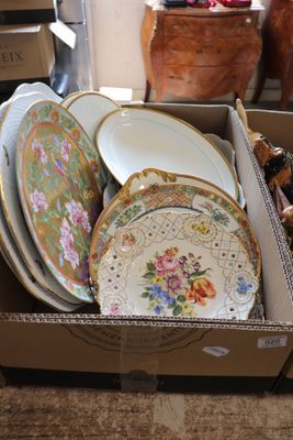 a box full of plates and bowls sitting on the floor