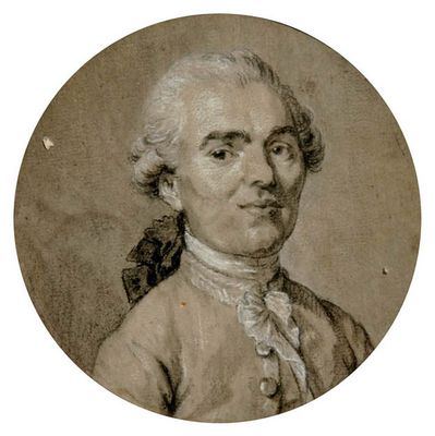 une vieille photo d'un homme aux cheveux blancs, vêtu d'une veste marron