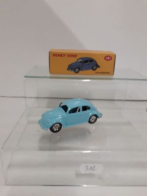 a small blue toy car on display in a glass case