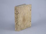 an old book sitting on top of a white surface